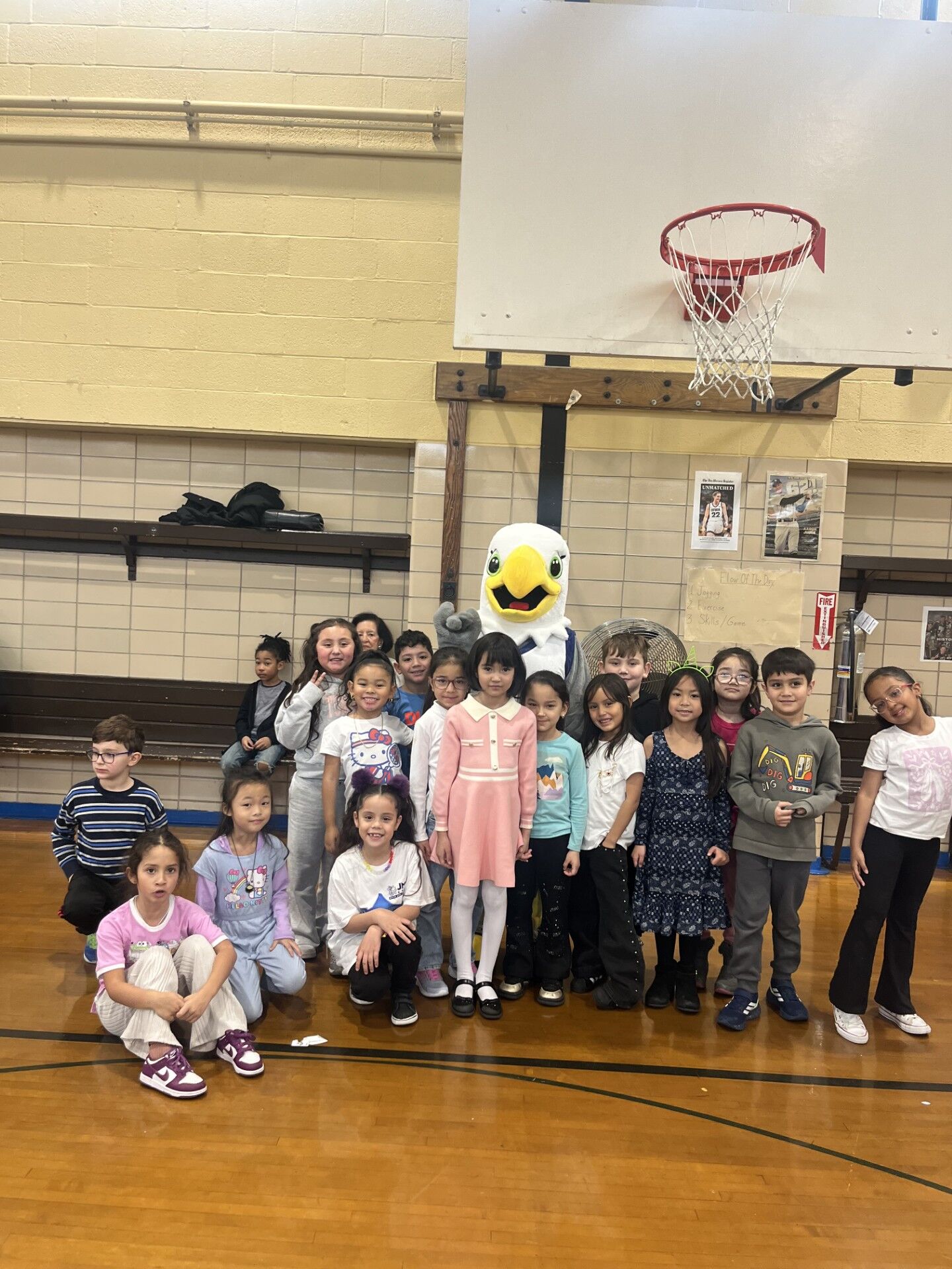 The Rego Eagle mascot with students at PS 139Q